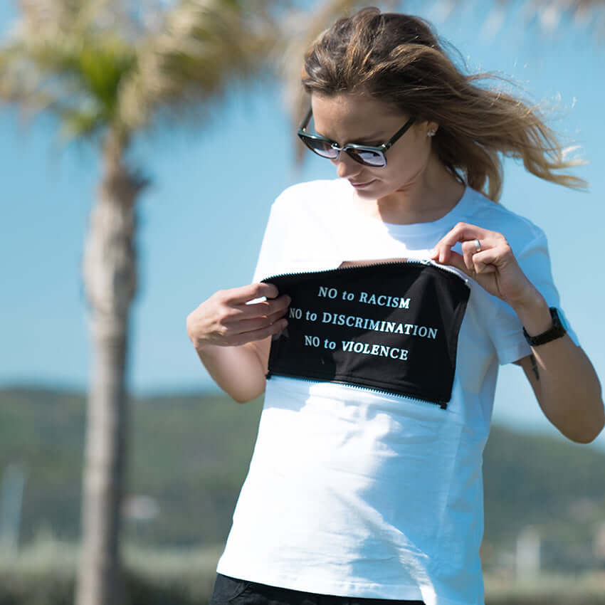 The woman is unzipping the patch on her MULTI shirt