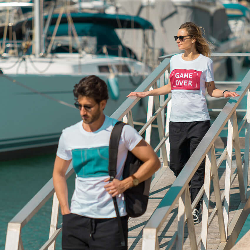 Man and woman get off the boat wearing MULTI t-shirts