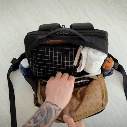 Man is putting wallet into the backpack