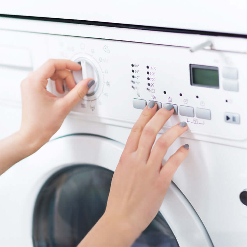 girl washes the backpack in the wash machine