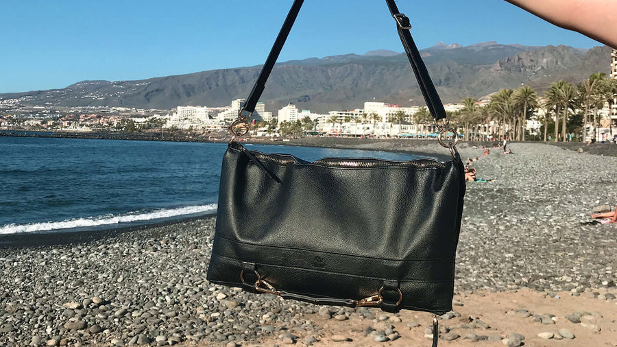 Black convertible purse on the sea background