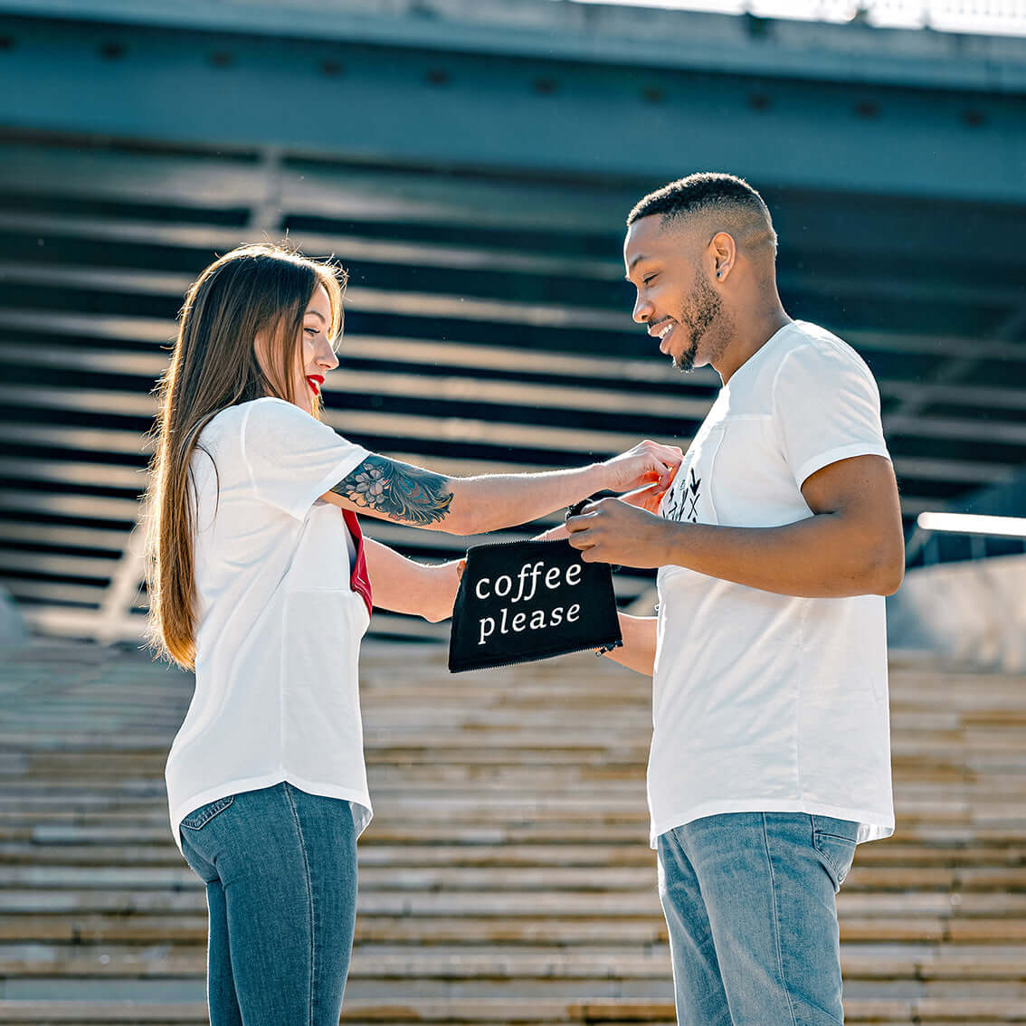 Man and woman exchange patches on their multi t-shirts